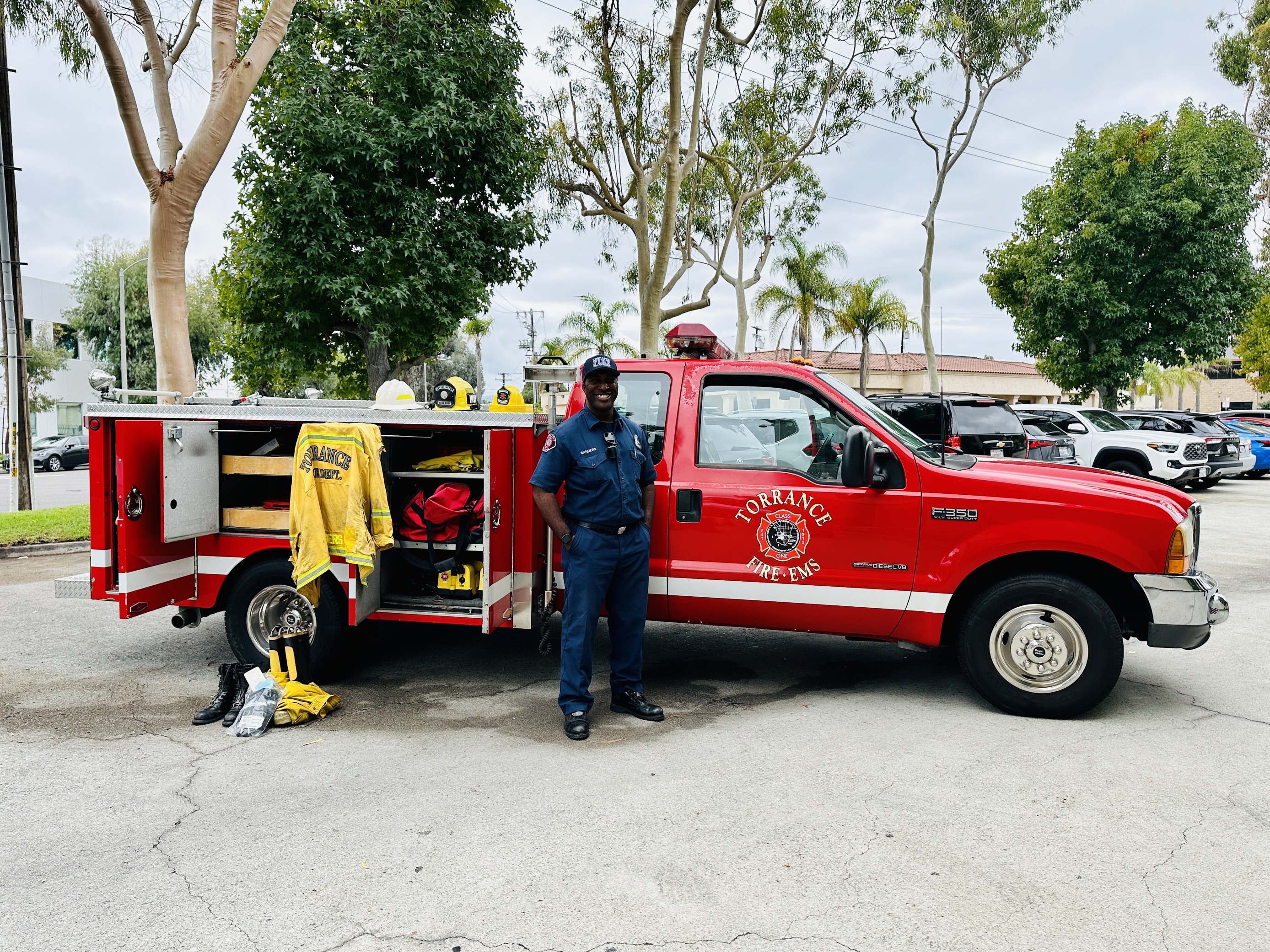Fire Inspector stands in front of their red truck