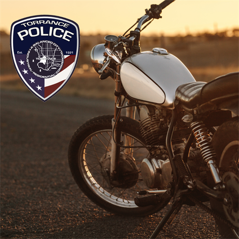 A Motorcycle in the background and a TPD Logo in the foreground