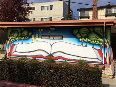 Exterior mural at El Retiro Library by Dean Bardos titled “If You Have a Garden and a Library”