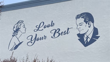 Mural at Injectability Clinic titled “Look Your Best” featuring a woman and a man in a vintage mid-century style.