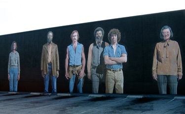 Mural by Kent Twitchell titled “Six Los Angeles Artists” featuring portraits of artists.