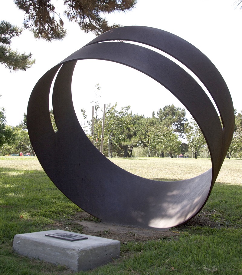 Sculpture at Columbia Park by Roger Berry titled “Fujimihara,” featuring a large circular metal form.