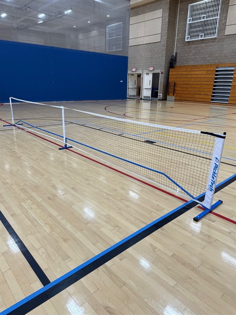 Indoor pickleball court and net.