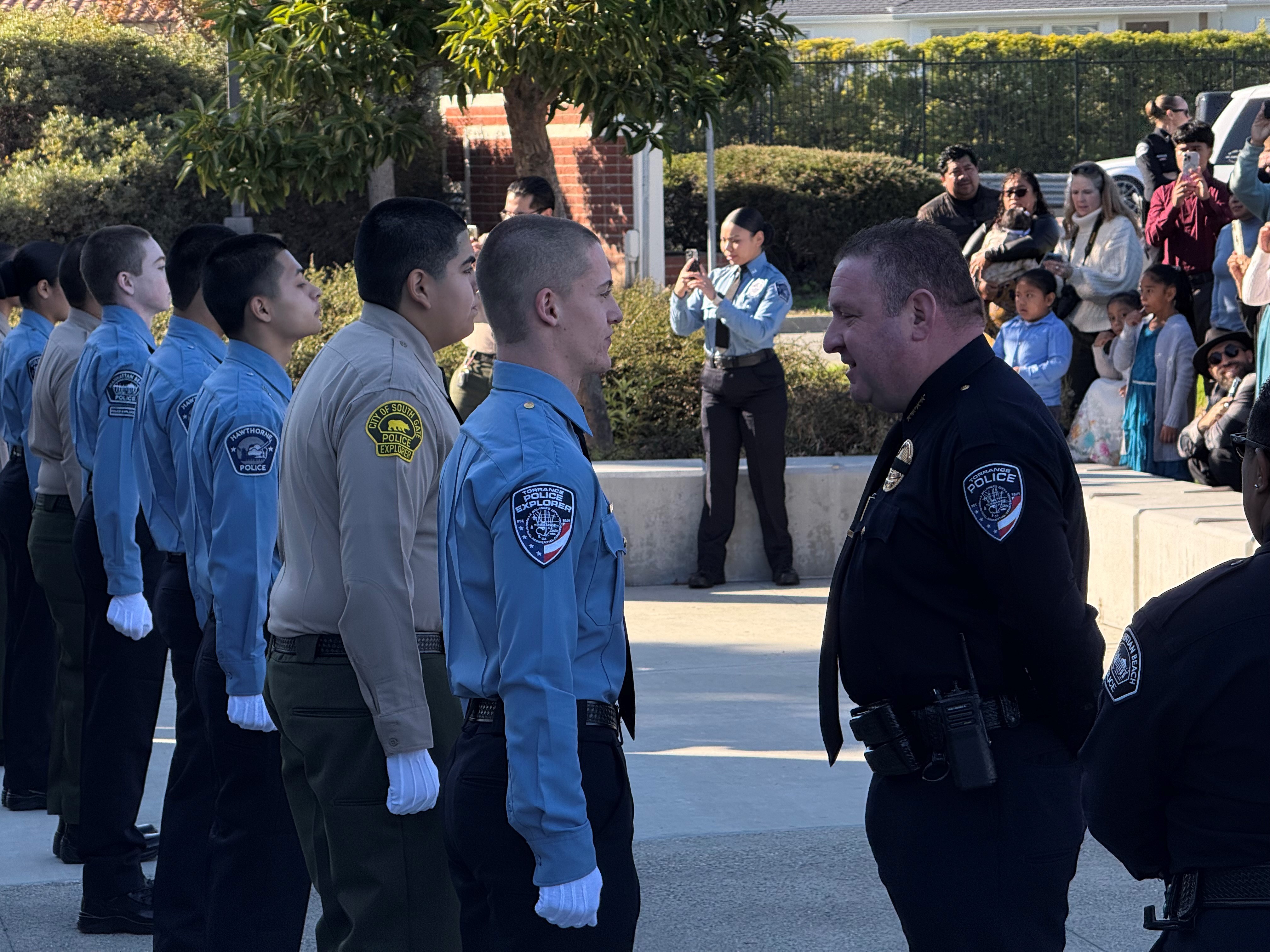 Officer in front of a line of Police Explorer Program participants